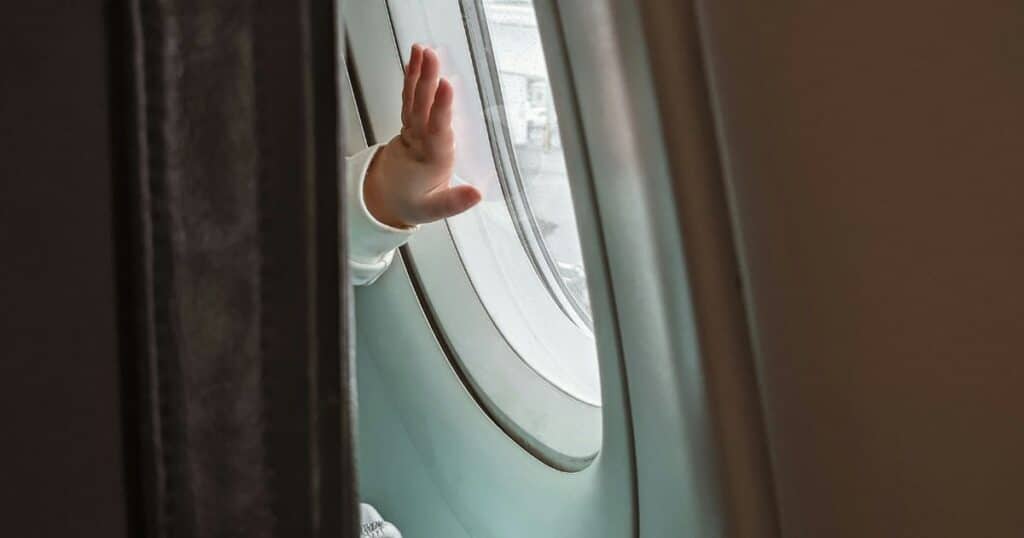 baby hand on airplane window