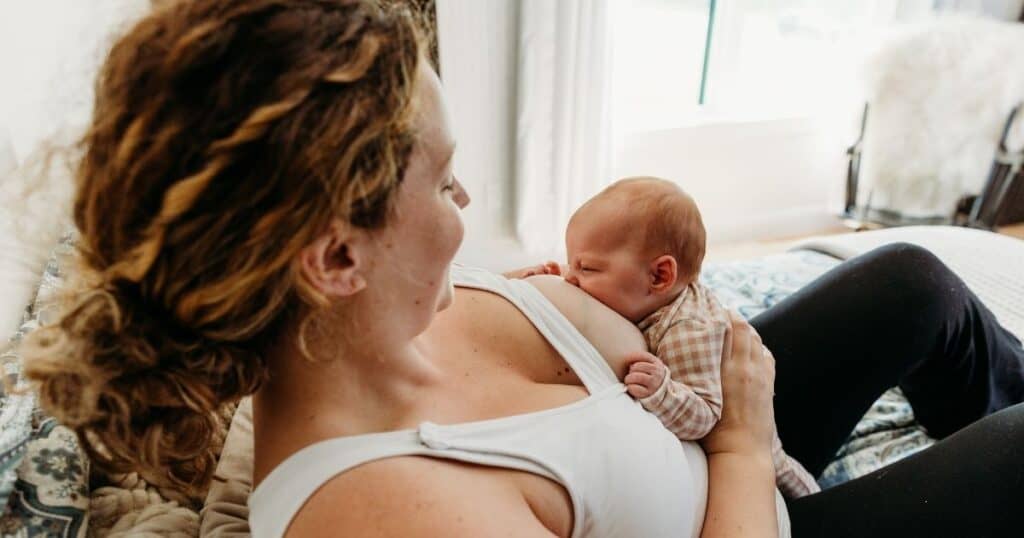 Mom breastfeeds baby in an upright position
