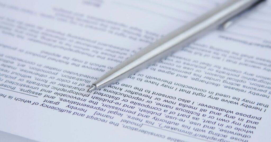 A pen sits on top of a document