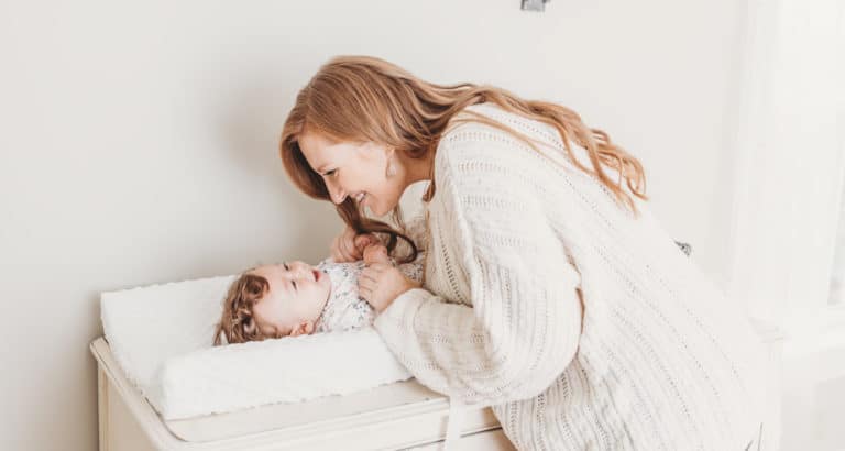 parent and baby on change table