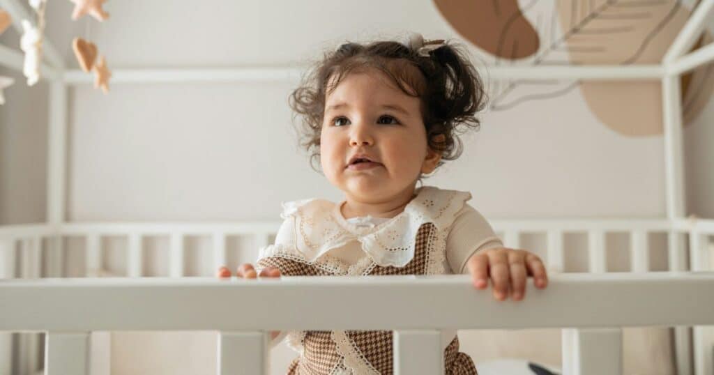 baby crawling out of crib
