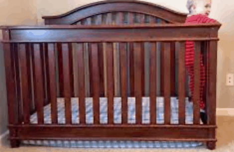 crib with mattress dropped to prevent baby from crawling out of crib