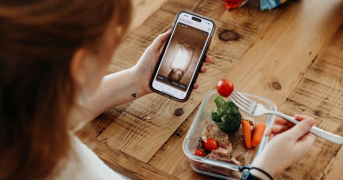 Postpartum Doula eats a healthy lunch while watching baby monitor