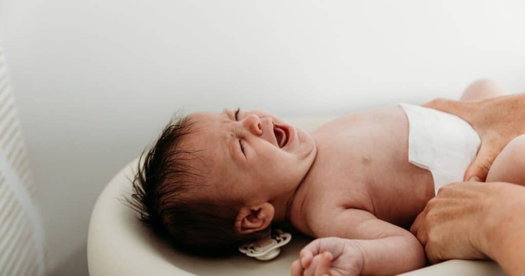 Baby cries on changing table