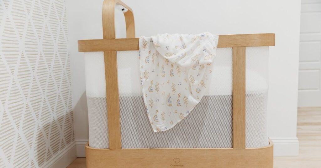 Loose blanket hangs in bassinet