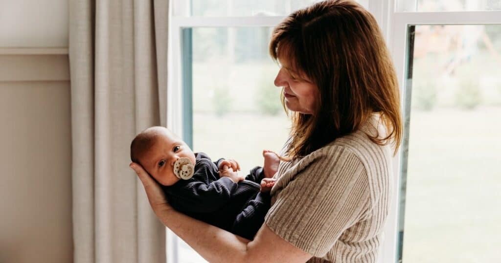 Newborn Care specialist cradles babu in arms