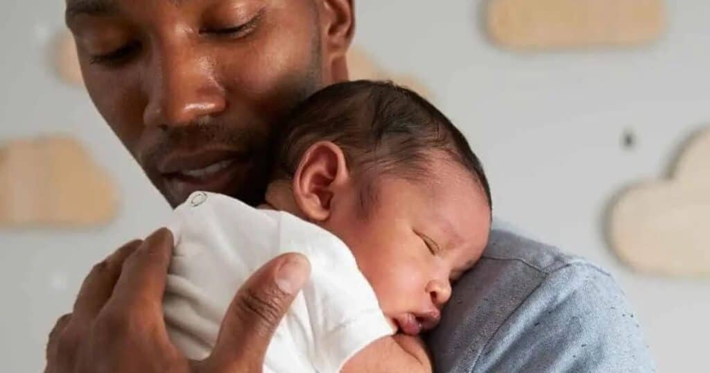 new dad holding baby