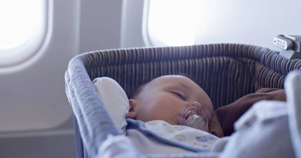 Baby sleeps comfortable in bassinet on plane