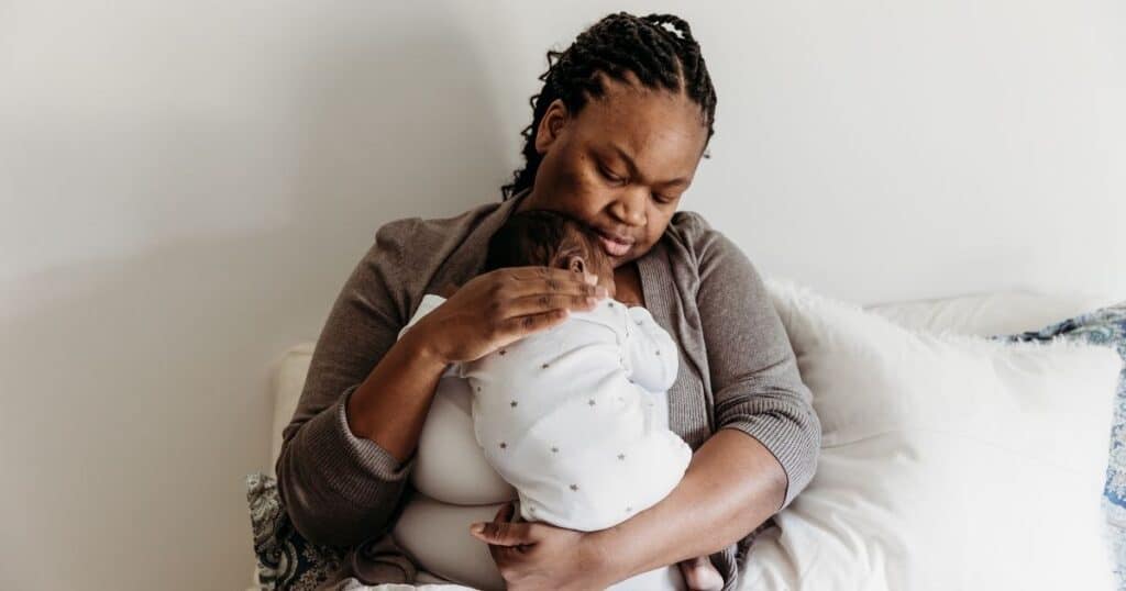 Mom holds baby to chest