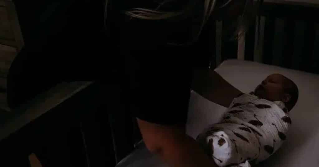 baby nurse at night placing baby in crib