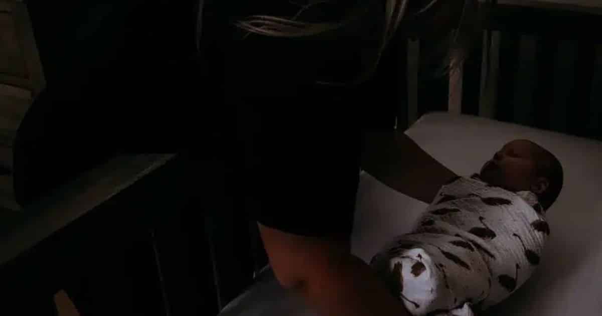 baby nurse at night placing baby in crib