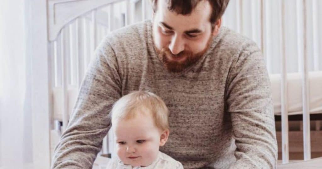 new york father with baby in nursery