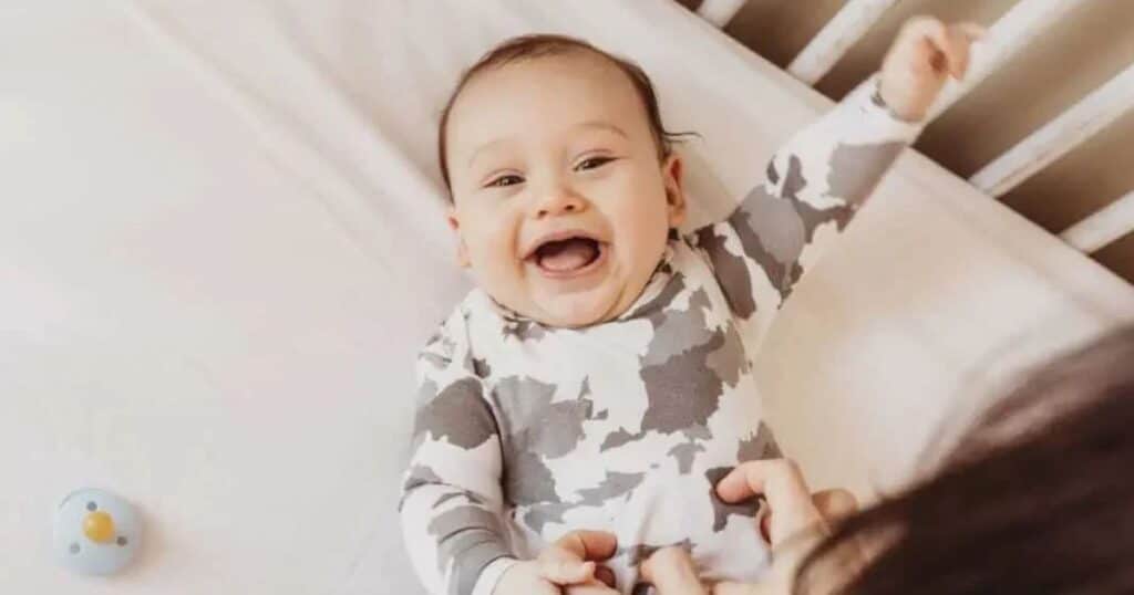 baby smiling in crib