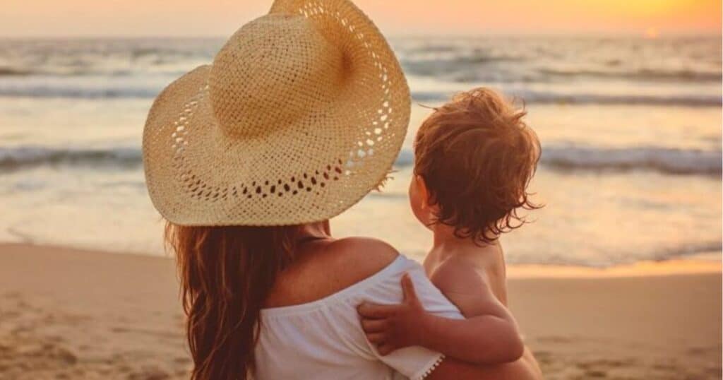 baby and mom at beach in florida summer heat