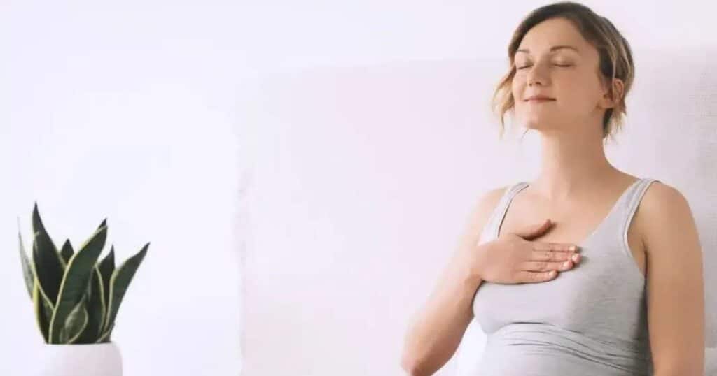 woman managing stress in pregnancy with meditation