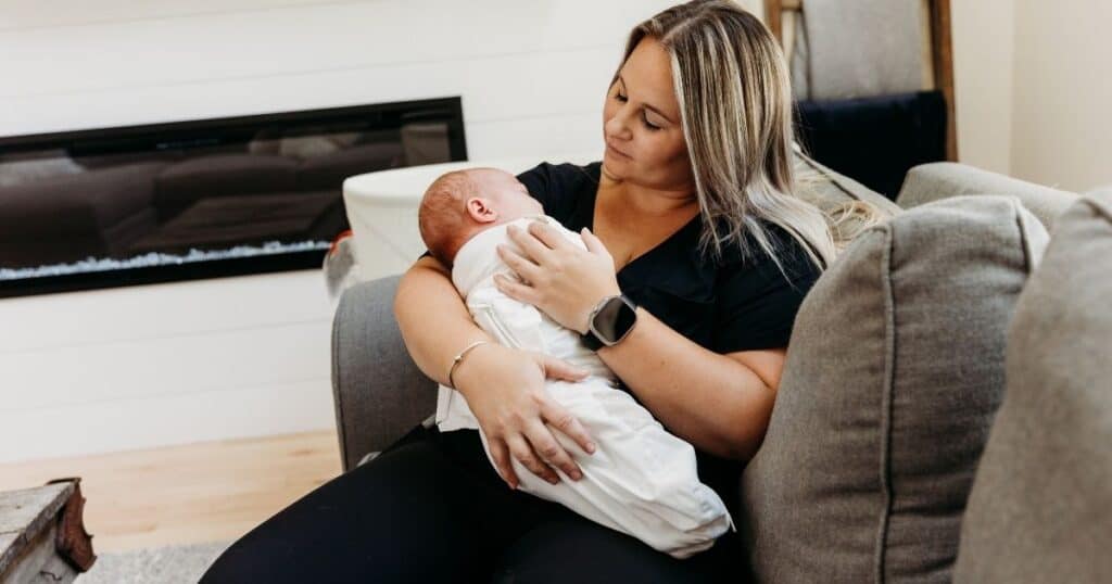 Postpartum Doula soothes baby on couch