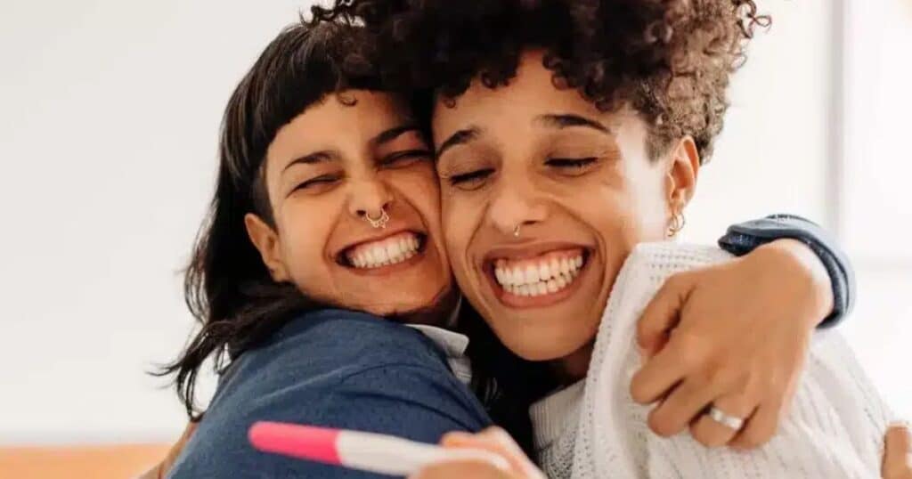 happy couple with positive pregnancy test in boston