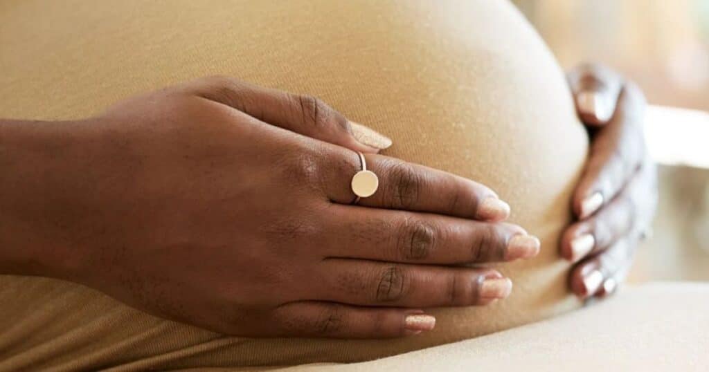 pregnant woman with hands on belly