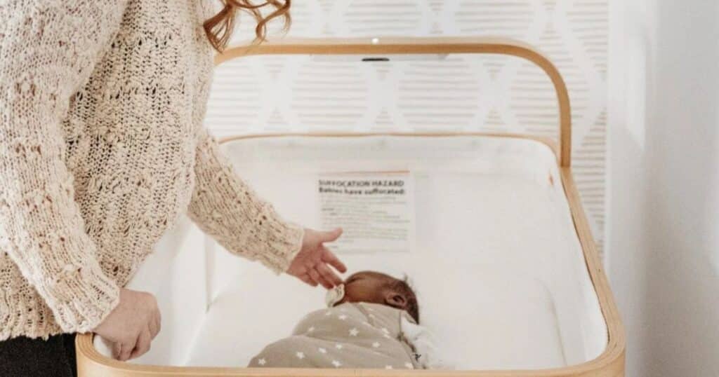 Baby asleep in Cradlewise crib.