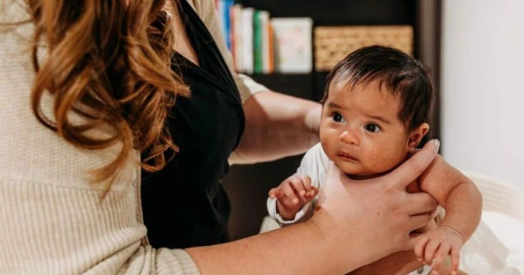 Newborn care specialist and baby.