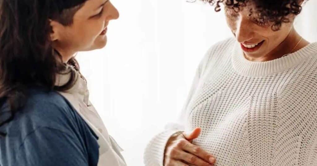 Pregnant couple celebrating.