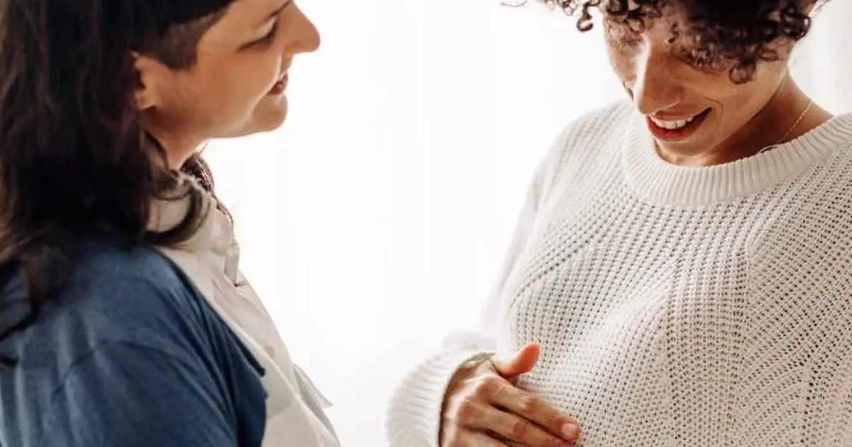 Pregnant couple celebrating.