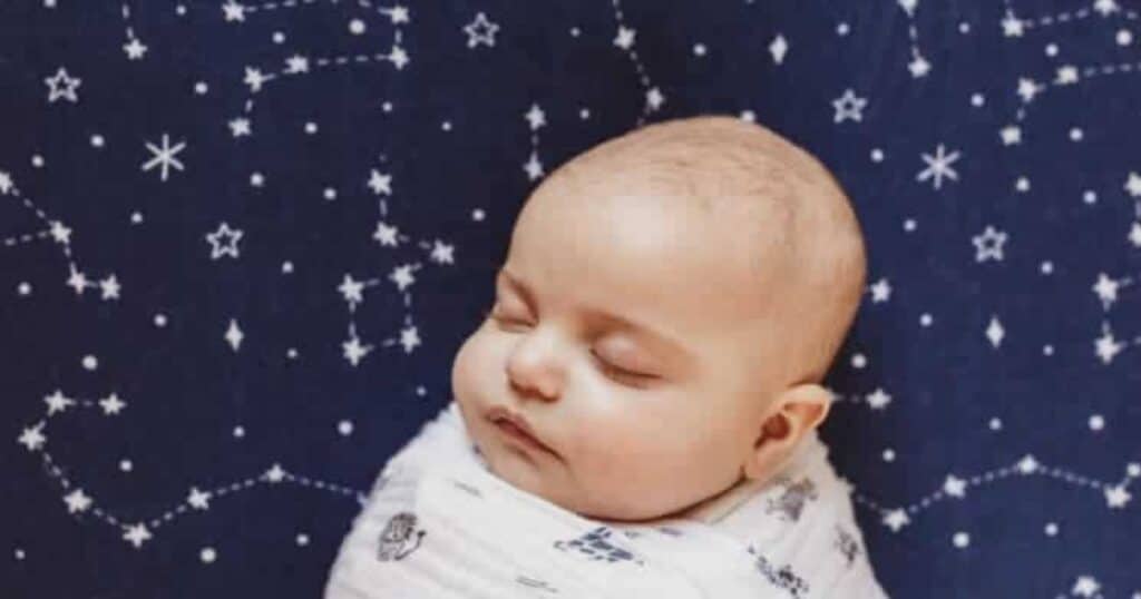 swaddled baby taking a nap