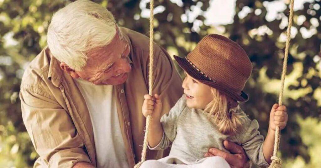 Child and grandpa on swing.
