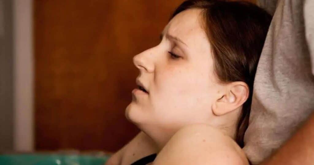 Woman in labor in birthing tub