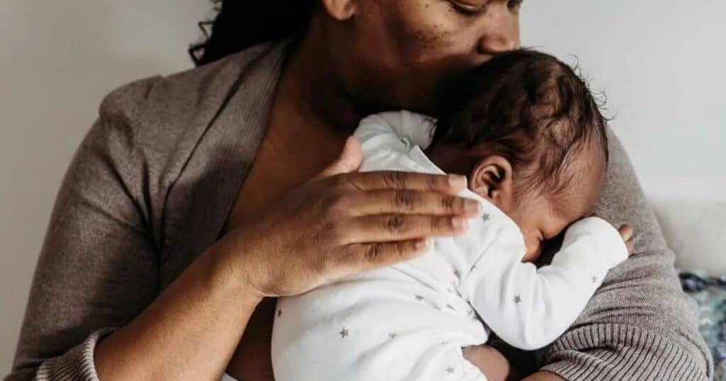 Mom cuddling her newborn baby.