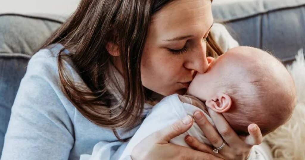 Mom kissing her baby.
