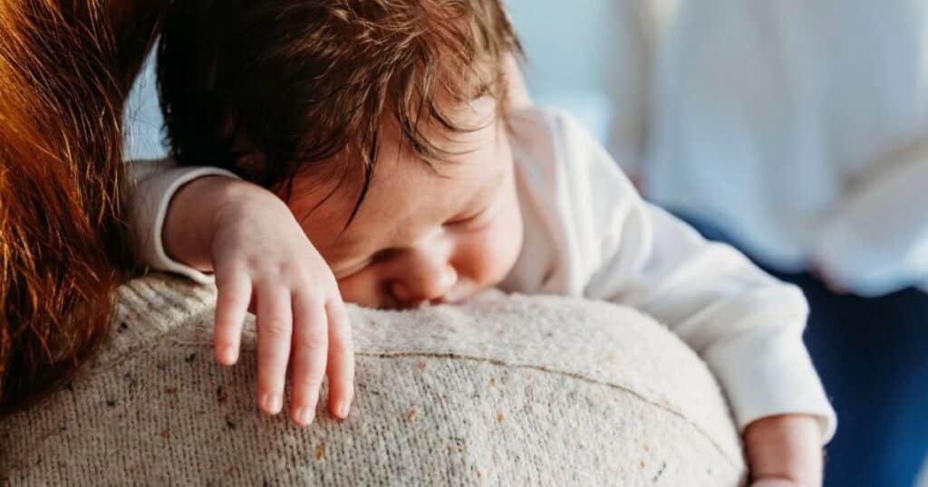 New mom holding her sleeping newborn.