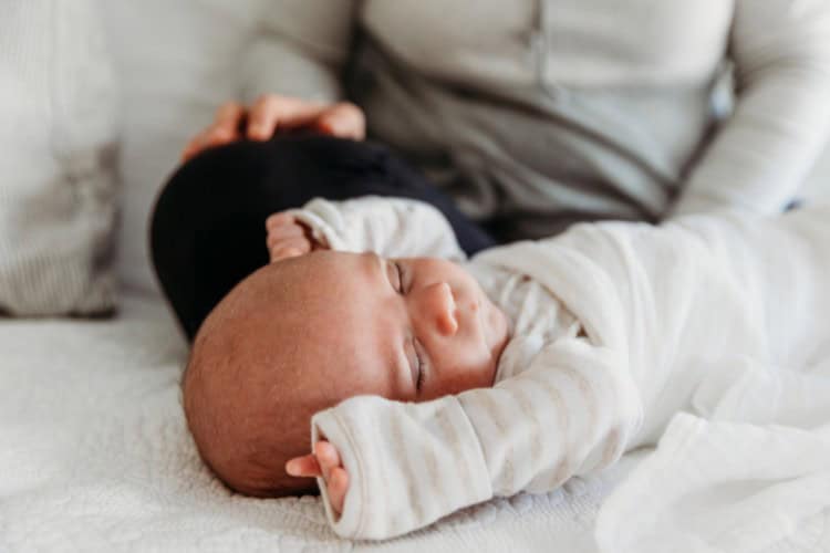 tired newborn stretch sleeping