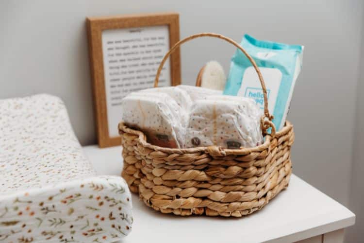 basket of baby essentials on change table