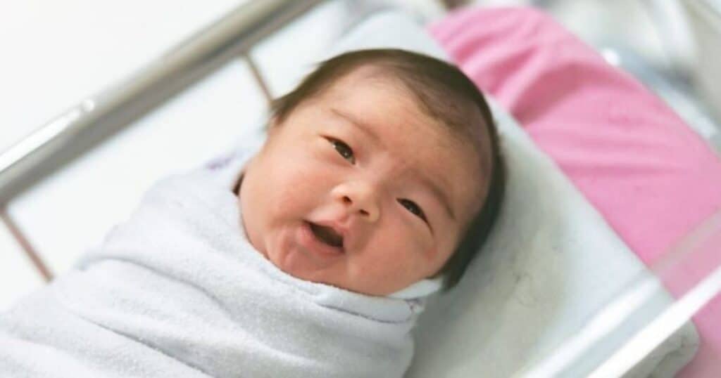 newborn baby in hospital crib