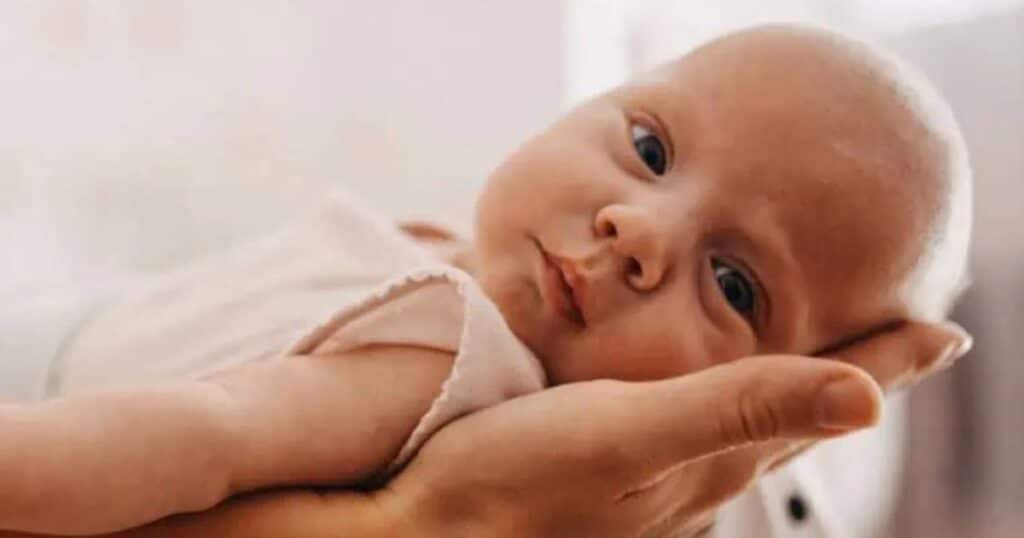 newborn baby in palm of hand