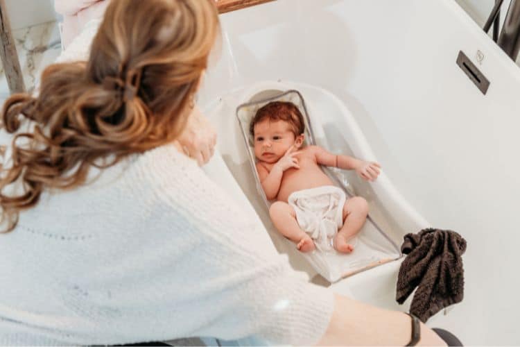 mom bathing baby as part of bedtime routine