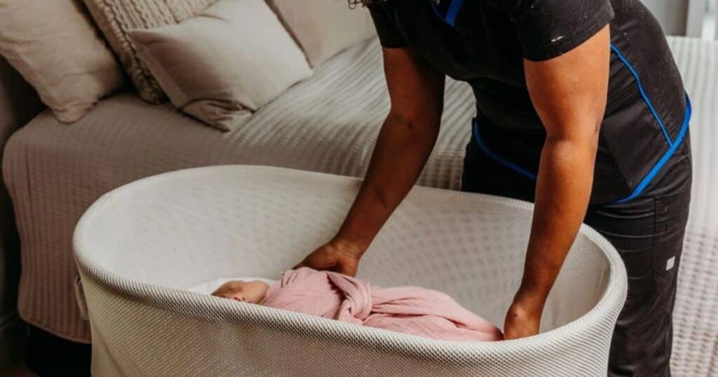 maine night nurse with baby in bassinet