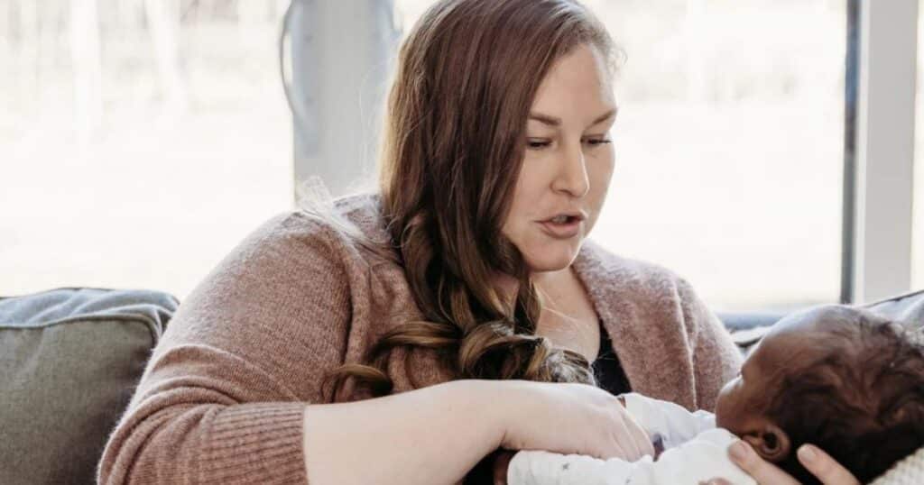 postpartum doula talking to baby to support brain development