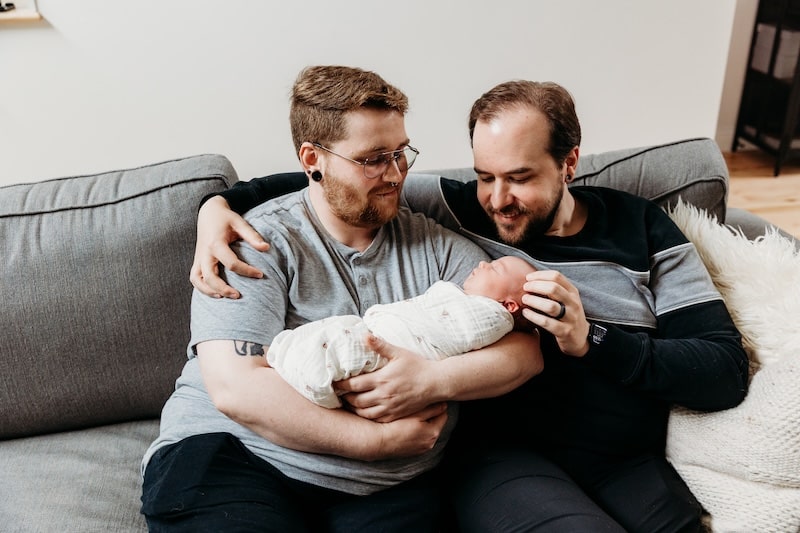 new intended parents with their newborn baby