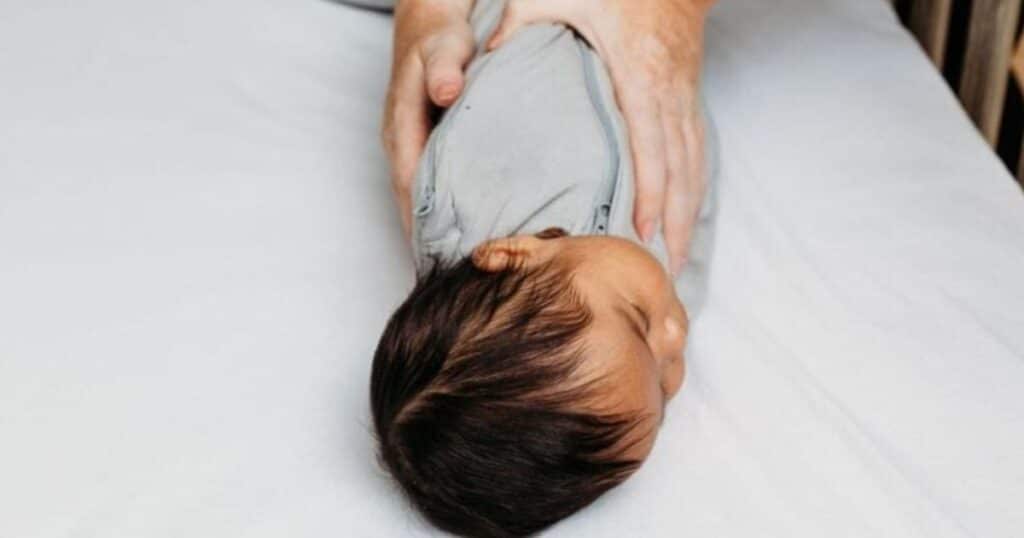 4 month old baby sleeping in swaddle