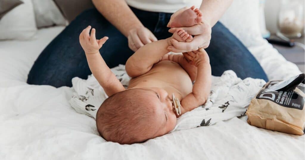 changing cloth diaper on baby
