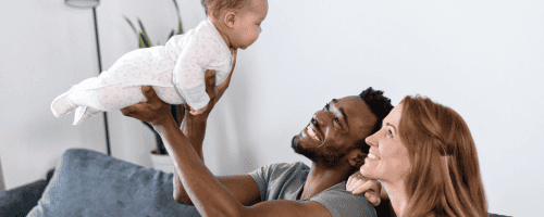 new parents gazing at baby