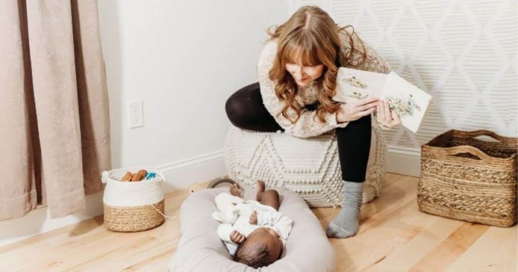 night nurse with baby on floor mat