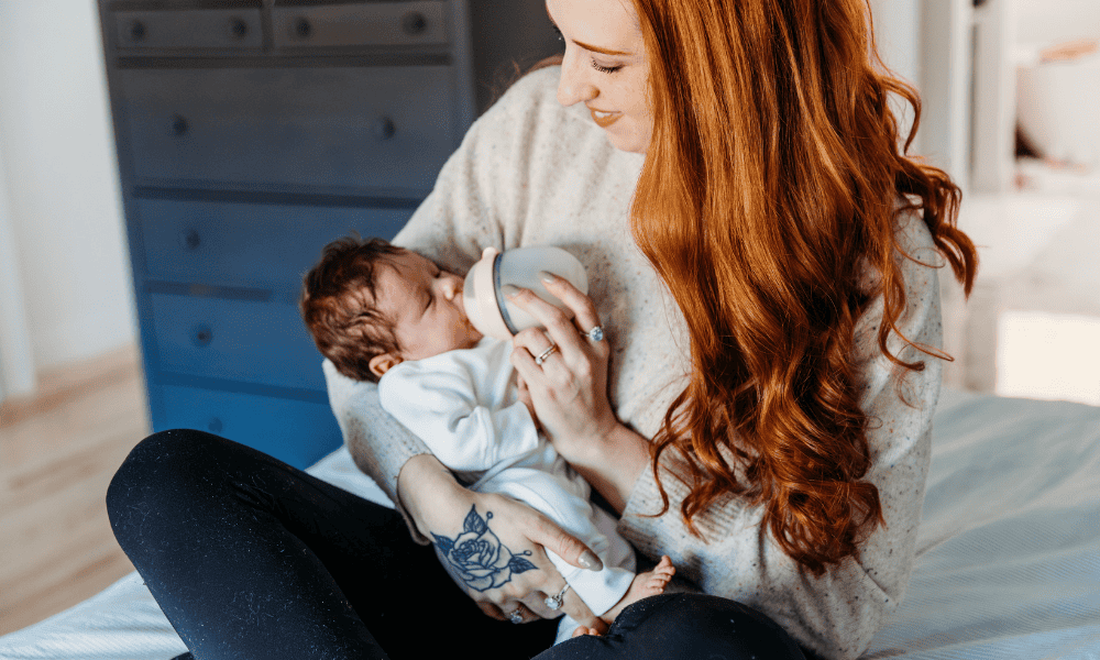 Doula bottle feds baby in lap