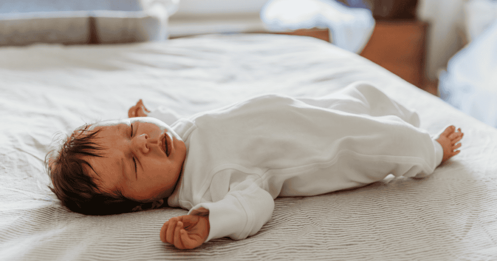 A rested sleeping baby with arms out
