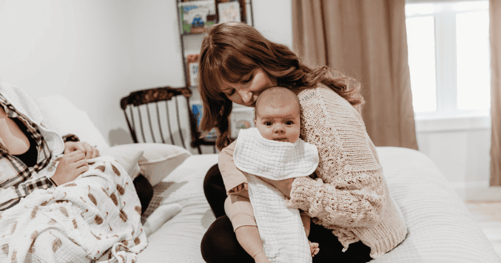 A CARROT Approved Postpartum Doula with a newborn