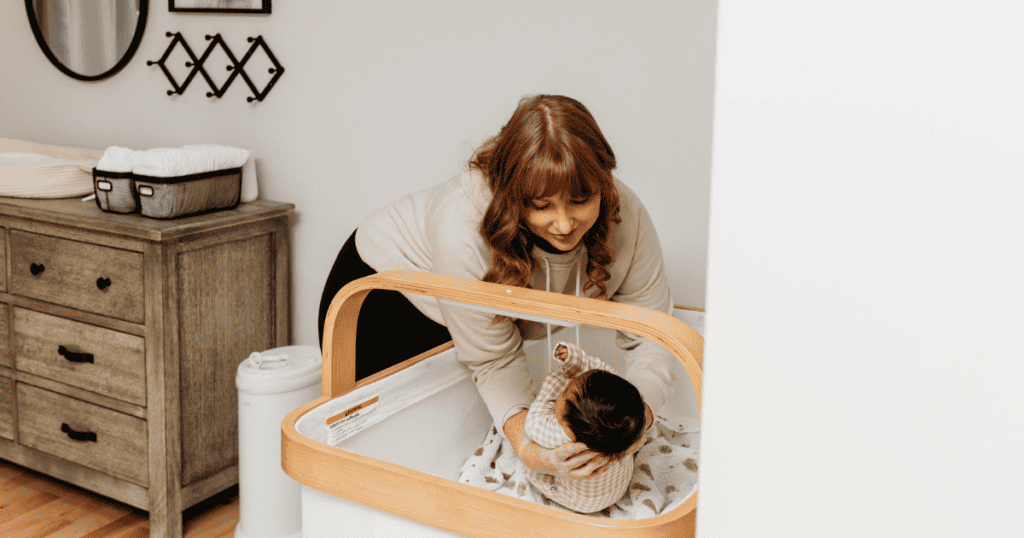 Newborn Care specialist putting baby to bed