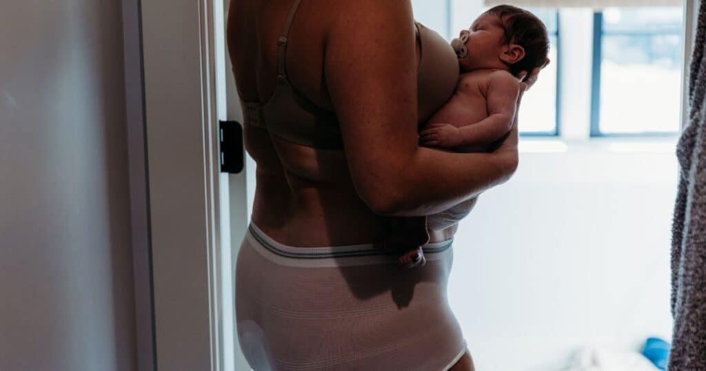 Postpartum mom and newborn in diapers