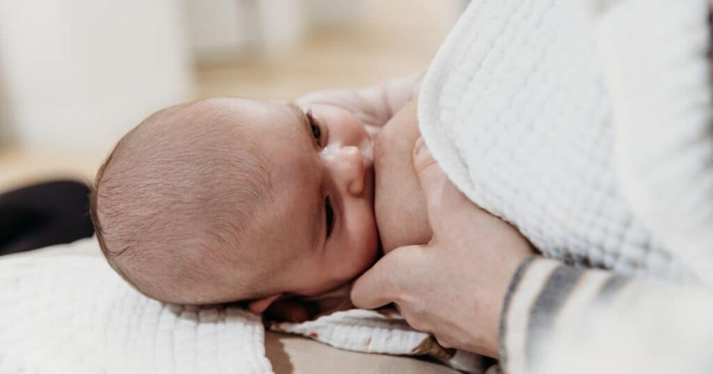 Mother nursing newborn